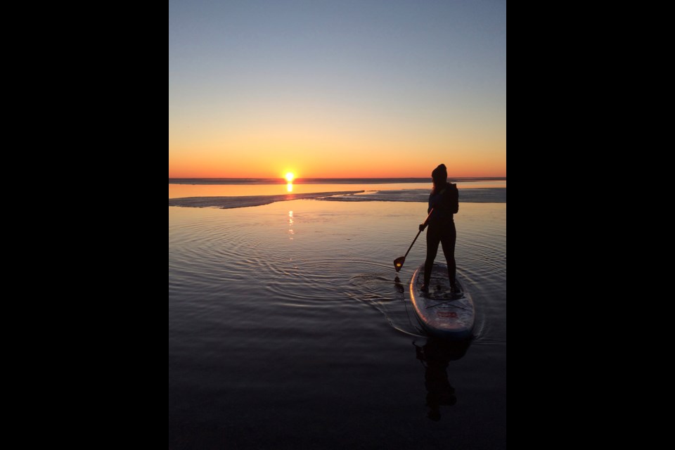 Avid paddler Michelle Bloom says she never ever regrets getting up early in the morning to enjoy a sunrise view from the water, something she continues to do in all seasons. Contributed photo