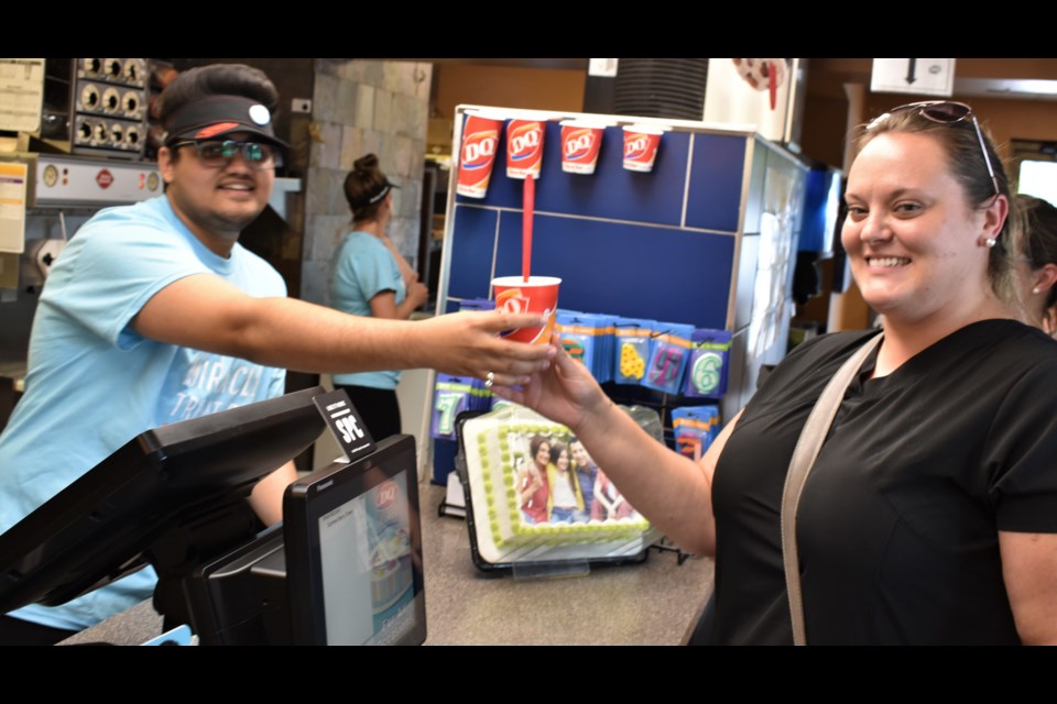 Keltie Smith, receiving her treat from Harsh Patel, was one of many who dropped into Orillia's Dairy Queen today to buy a Blizzard - not just to beat the heat, but to help raise money for a good cause. Today is Miracle Treat Day and that means net proceeds from every Blizzard Treat sold will be donated to a local Children’s Miracle Network member hospital. You still have lots of time; Orillia's Dairy Queen (on Memorial Avenue) is open today until 10 p.m. Dave Dawson/OrilliaMatters