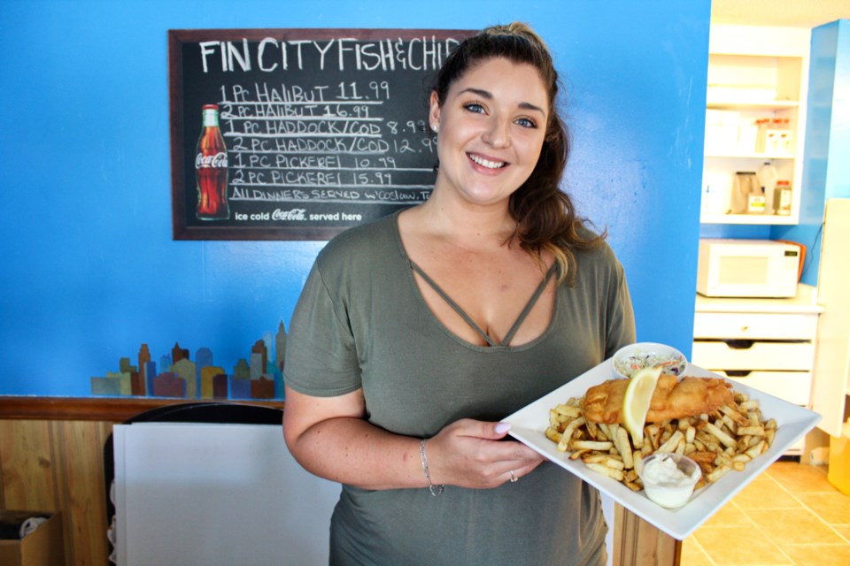 Jaclyn Boyd shows off the halibut and chips at Fin City Fish and Chips in Orillia. Nathan Taylor/OrilliaMatters