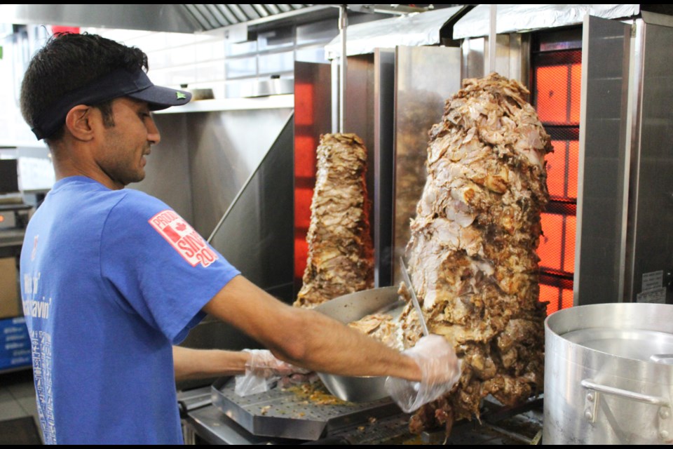 Hiren Patel, co-owner of Osmow's in Orillia, prepares shawarma Thursday. Nathan Taylor/OrilliaMatters