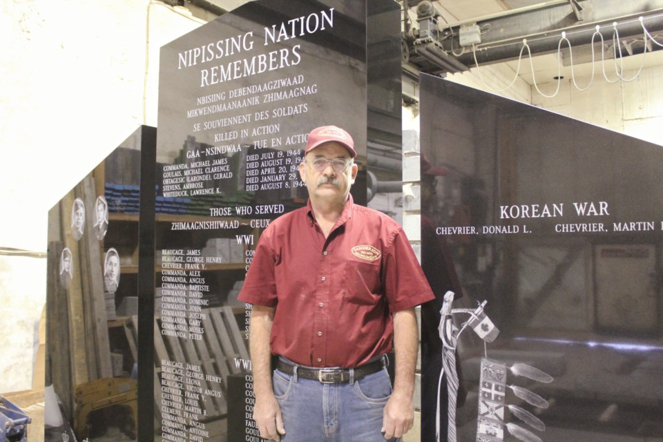 Eric Schop is shown with a war memorial he's been working on at Sanderson Monument. Schop is celebrating 45 years of employment with the Orillia business. Nathan Taylor/OrilliaMatters