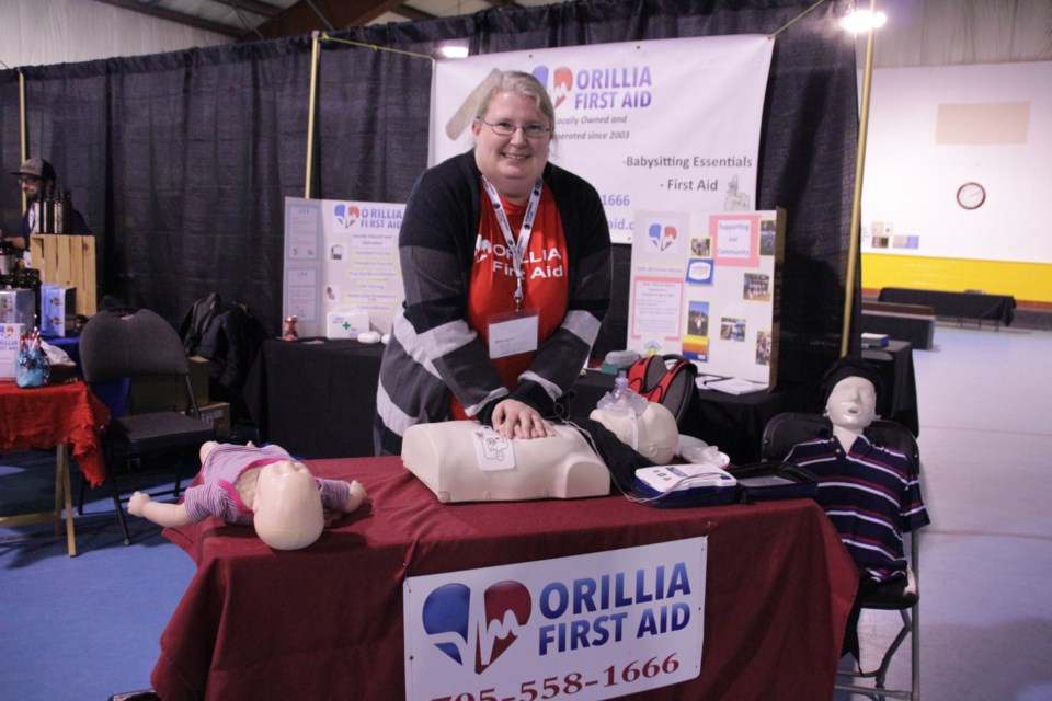Nicole Kasurak, of Orillia First Aid, demonstrated CPR on a doll. Photo by Mehreen Shahid for OrilliaMatters