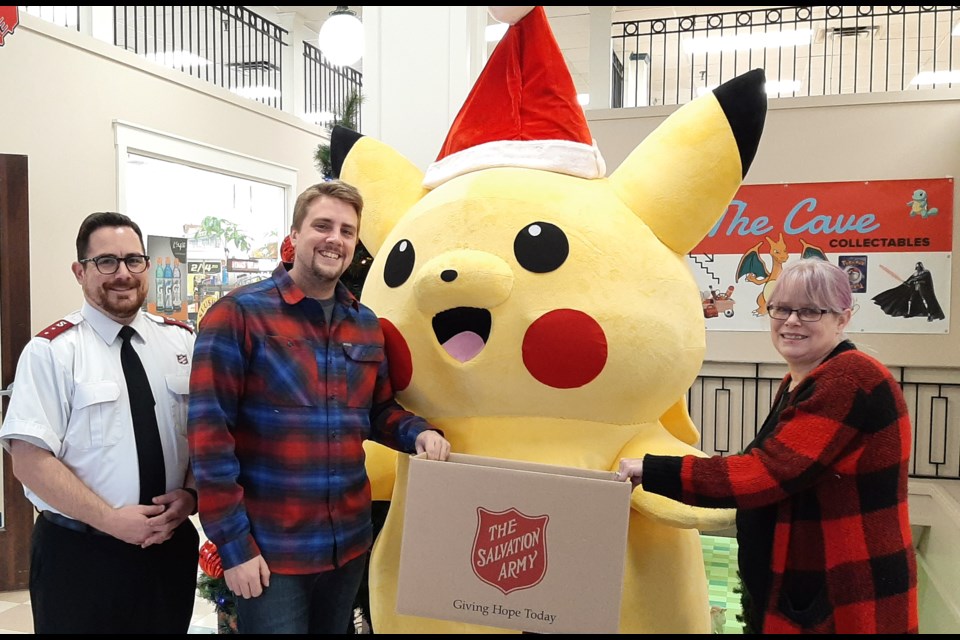 From left: Salvation Amy Captain Josh Howard, The Cave Collectables store manager Josh Nixon, Pikachu and Oscars Variety co-owner Heather Fraser will welcome the community to Holiday Hoopla on Saturday.