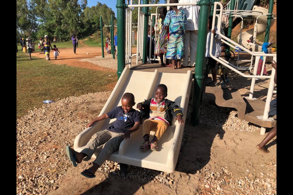 Children show sheer joy as they experience a slide for the first time after Where Angels Play volunteers built a playground in their community of Kibeho, in Rwanda. Photo provided