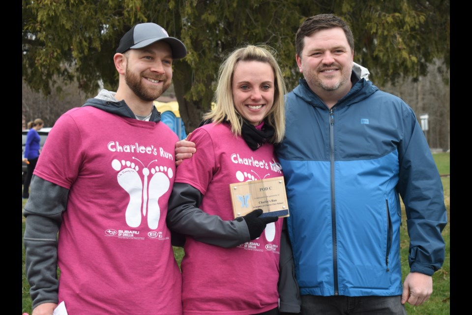 Dave and Mallory Holmes were overcome with emotion at last year's run when Orillia Soldiers’ Memorial Hospital Foundation executive director Mark Riczu unveiled a plaque to honour their daughter and the legacy run named in her honour. Dave Dawson/OrilliaMatters
