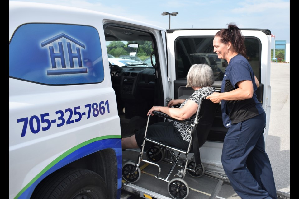 Rebecca Anderson, a PSW at Helping Hands, helps Barb Martin, the executive assistant to Helping Hands’ board, into one of their vans. The agency is in desperate need of volunteers. Dave Dawson/OrilliaMatters