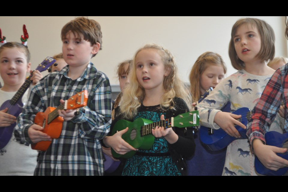 Eight-year-old Capri Malone, centre, performed as part of the Hummin’ and Strummin’ Ukulele kids Saturday afternoon at Thor Motors. Andrew Philips/Orillia Matters