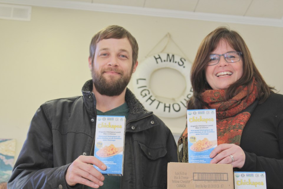 Nathan Taylor, a member of United Way Simcoe Muskoka's board of directors and GenNext team, is shown with Linda Goodall, executive director of the Lighthouse Shelter in Orillia. Taylor dropped off a donation of mac and cheese Tuesday on behalf of GenNext. Supplied photo