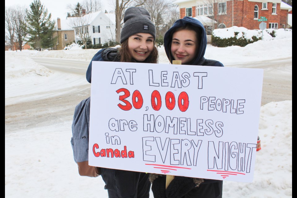 Patrick Fogarty Catholic Secondary School students Ally Metras, left, and Drew Hook served as crossing guards for their fellow students during Thursday's Coldest Day of the Year walk. Nathan Taylor/OrilliaMatters