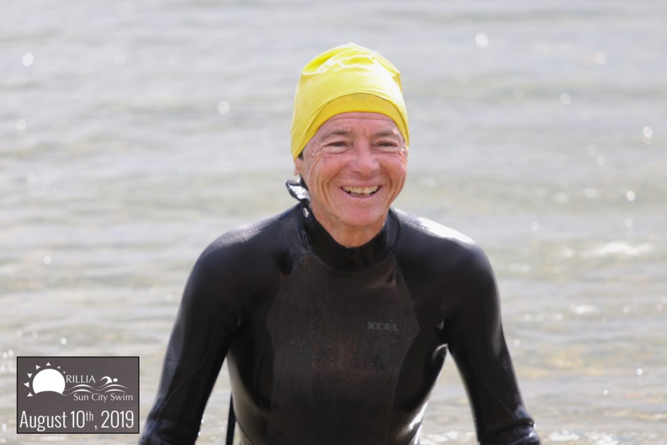 Sun City Swim founder Brenda Jenkins comes ashore Saturday at Couchiching Beach Park after swimming across Lake Couchiching. Ron Jenkins/Supplied photo