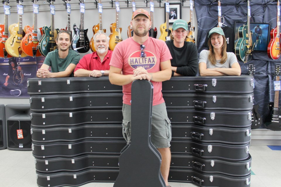 This stack of guitars will be going to Patrick Fogarty Catholic Secondary School thanks to last month's Strings for Students fundraising concert. Pictured Saturday at Gilbert Guitars are, from left, Cole Perkins, of Bleeker, Gilbert Guitars owner Jeff Gilbert, Jimmy Johnston, of the Doug Trucker Band, Taylor Perkins, of Bleeker, and Samantha Vessios, who looked after marketing and promotions for the fundraiser. Nathan Taylor/OrilliaMatters