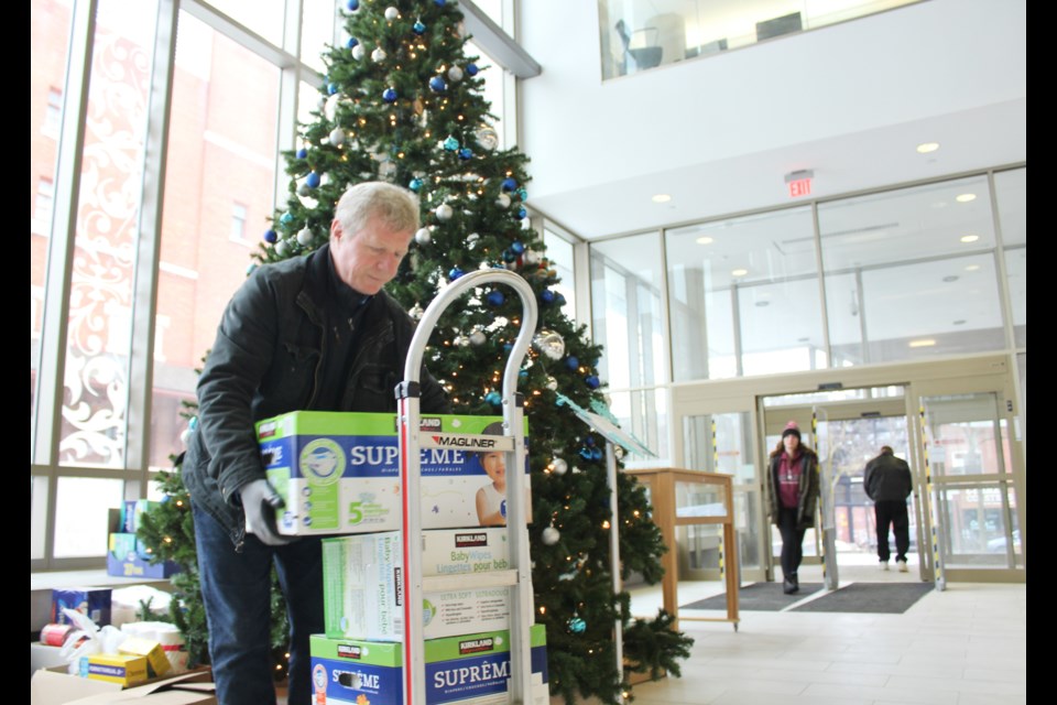 Andy Breininger, a volunteer with The Sharing Place Food Centre, was at the Orillia Public Library on Friday to pick up items collected during an annual drive. Nathan Taylor/OrilliaMatters
