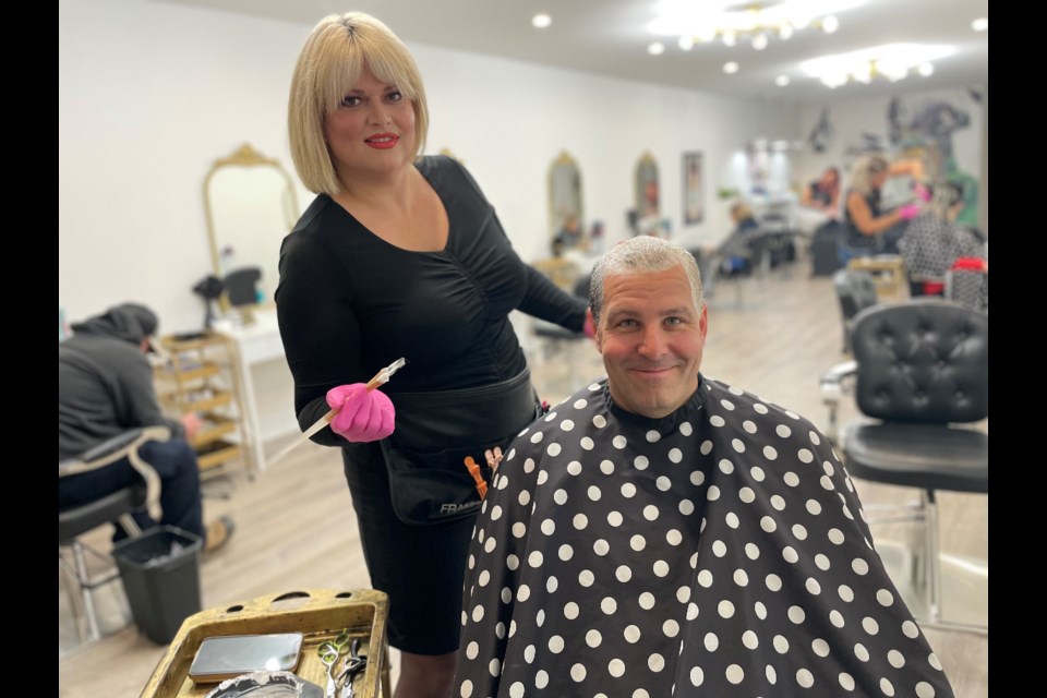 Helping Hands executive director Doug Rawson spent Wednesday afternoon with Tiffany Robertson, of Tiffany's Hair & Co., getting his hair dyed blue as part of a fundraising drive to purchase a new vehicle for the local agency.