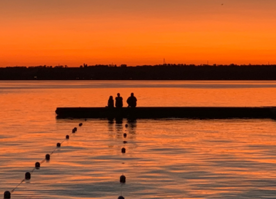 A family enjoys a sunset on the dock at Geneva Park in this file photo. The property was sold this week to a private developer.
