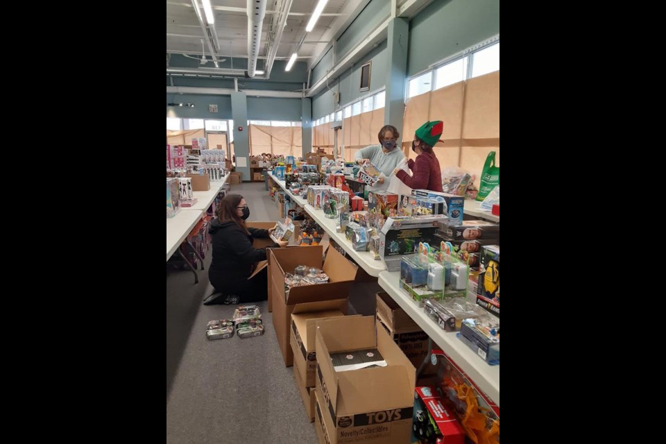 Simcoe Family Connexions volunteers are hard at work sorting through toys for the annual Holiday Program that benefits vulnerable families in Orillia and other communities in Simcoe County and Muskoka. 