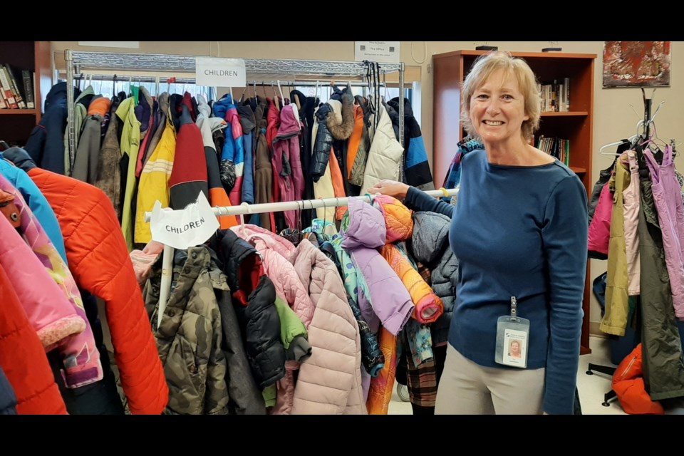 Sue Learmonth, the co-ordinator of the Orillia Learning Centre, is shown with some of the children's coats available for those in need.