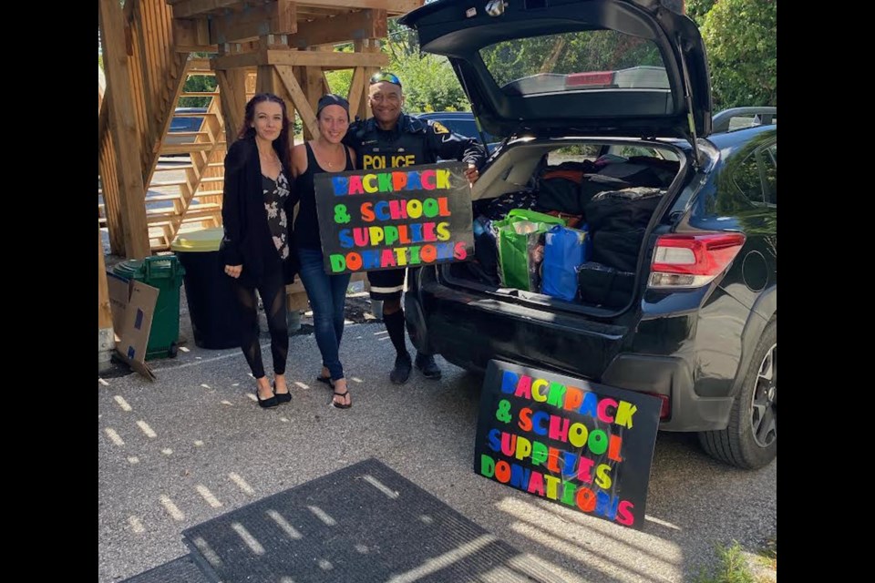 Members of Uplifting Blessings and Orillia OPP have collected about 600 backpacks full of supplies for children who are going back to school next week. From left are volunteer Alicia McLeod, Uplifting Blessings founder Carolyn-Marie Goodwin and Orillia OPP Const. Grant Geldenhuys.