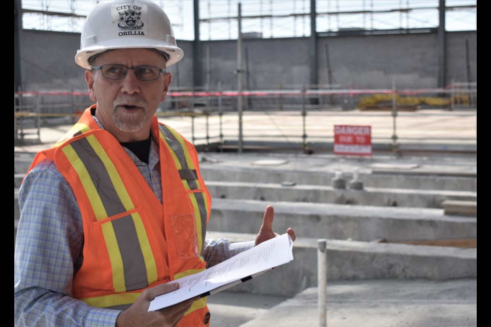 Ray Merkley, the city’s director of parks, recreation and culture, provides details about the three pools inside the recreation centre being built on West Street. Members of the media and city politicians had a tour of the facility Wednesday. Dave Dawson/OrilliaMatters