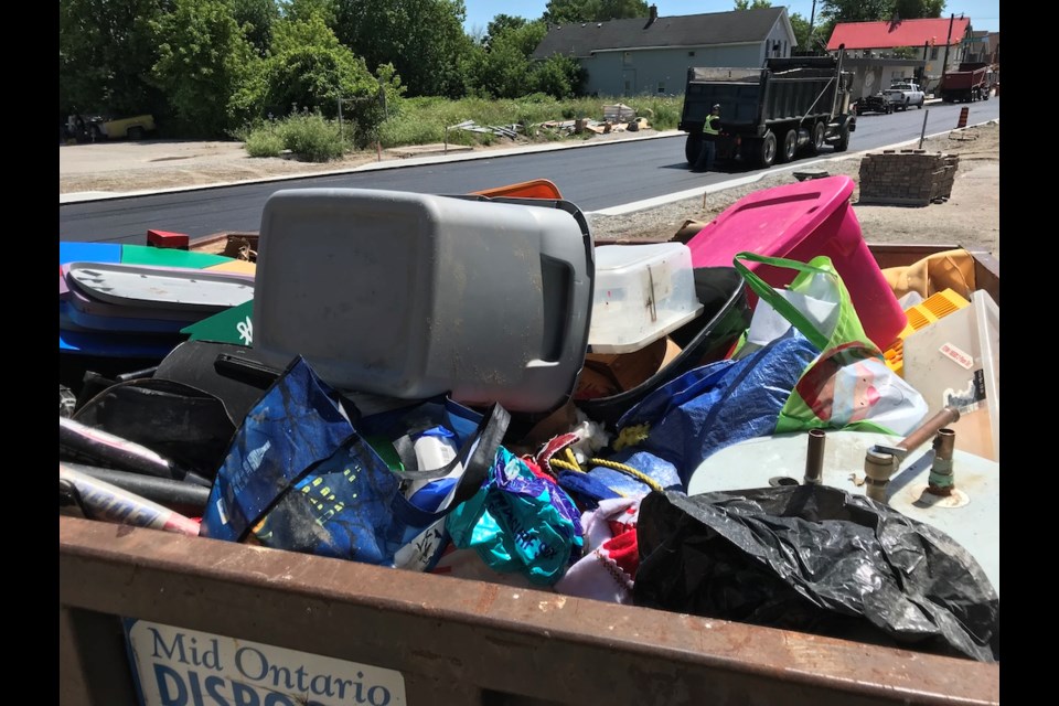 Volunteers and staff from the Orillia Youth Centre filled more than a dumpster full of valuables destroyed by a flooded basement discovered on Thursday morning. Contributed Photo.