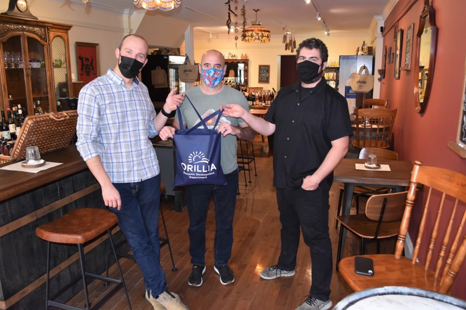 PICNIC Snack Bar won the Orillia Foodies Unite! Business draw, taking home a shop local prize pack containing City of Orillia swag and a gift certificate from a local business. Left, PICNIC co-owners Simon MacRae, Darcy MacDonell, and Joel Bennett.
