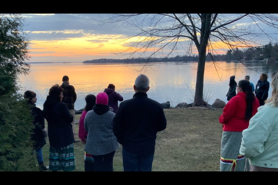 A sunrise ceremony is held on the shores of Lake Simcoe.