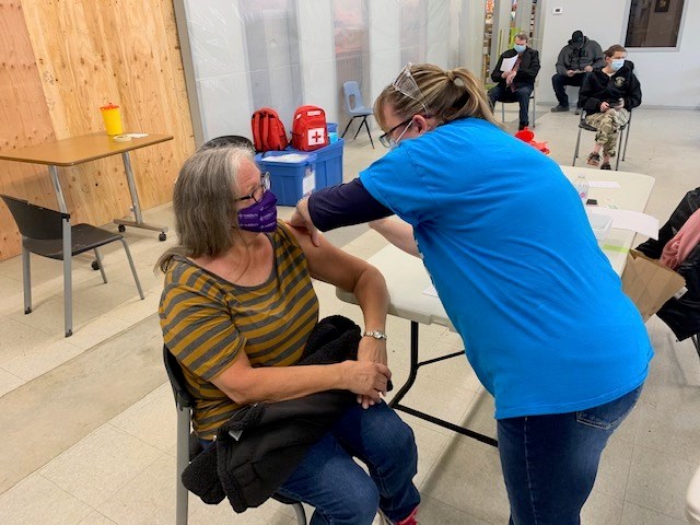 Louanne Black receives the COVID-19 vaccine during a recent clinic at The Sharing Place Food Centre.
