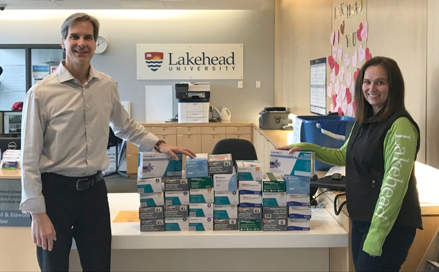 Dr. Dean Jobin-Bevans, Principal of Lakehead Orillia, and Rebecca Heffernan, Research and Strategic Initiatives Facilitator, accepted more than 4,000 pairs of gloves that went to the Orillia Soldiers' Memorial Hospital. Contributed photo