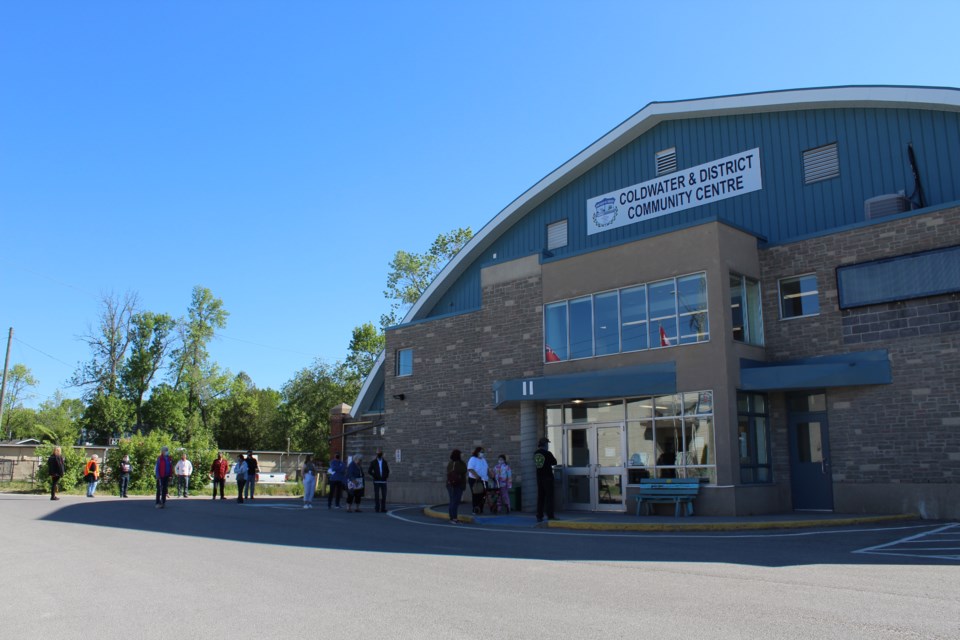 Patients waiting to be vaccinated lined up outside the Coldwater Community Centre prior to the doors opening at 9:30 a.m. Saturday morning.