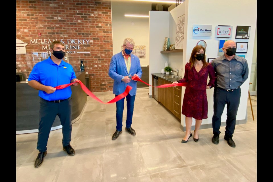On hand for a ribbon-cutting ceremony Tuesday at McLean and Dickey Insurance were, from left, McLean and Dickey partner Sylvain Tisi, Mayor Steve Clarke and McLean and Dickey partners Danielle Tisi and Mike Holenski.
