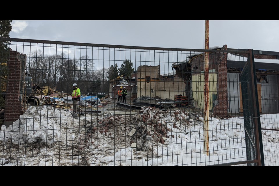 Workers from The Cannington Group sift through the rubble after punching through what was once the front entranceway of Mount Slaven. You can see the old school logo on the wall of the former gymnasium. Dave Dawson/OrilliaMatters