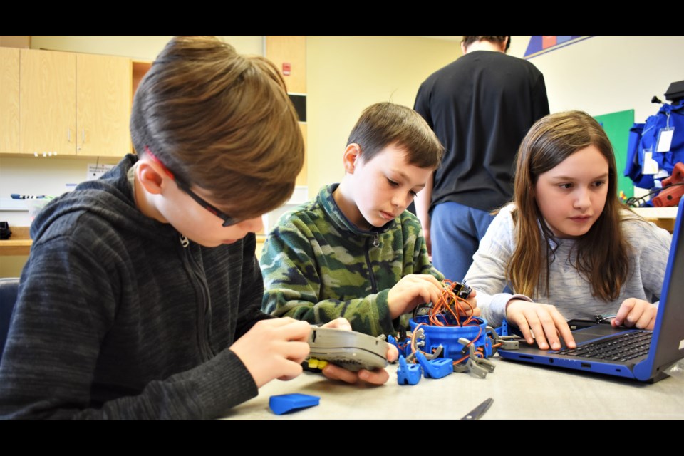 Grade 5 students, from left, Aidan Granulo, Aidan Sedore and Ava Cassar work on a robot they are building. They used the lab’s 3D printer to create a case and game pad and are busy assembling the mechanics and electronics. Dave Dawson/OrilliaMatters