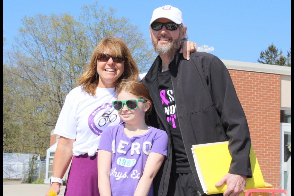 Jeff Munn is pictured with Guthrie Public School teacher Pamela Lee and student Lacey Pollock. The school held a bike-a-thon Wednesday to show its support for Munn, who has pancreatic cancer. Nathan Taylor/OrilliaMatters