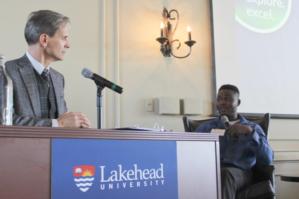 Dean Jobin-Bevans, left, principal of Lakehead University's Orillia campus, speaks with student Bolu Fabanwo on Wednesday during Lakehead's Report to Community at the Hawk Ridge Golf and Country Club. Nathan Taylor/OrilliaMatters