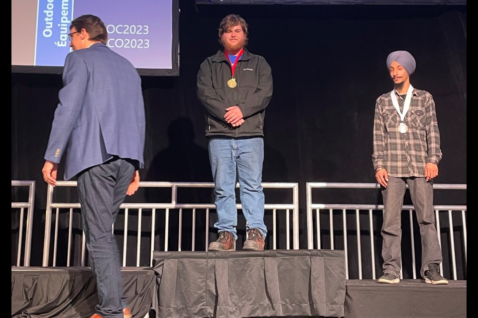 Xander Powell, middle, a student in Georgian College’s mechanical techniques—marine engine mechanic program, is shown on the podium for his gold-medal win in the outdoor power equipment category at the Skills Ontario Competition.