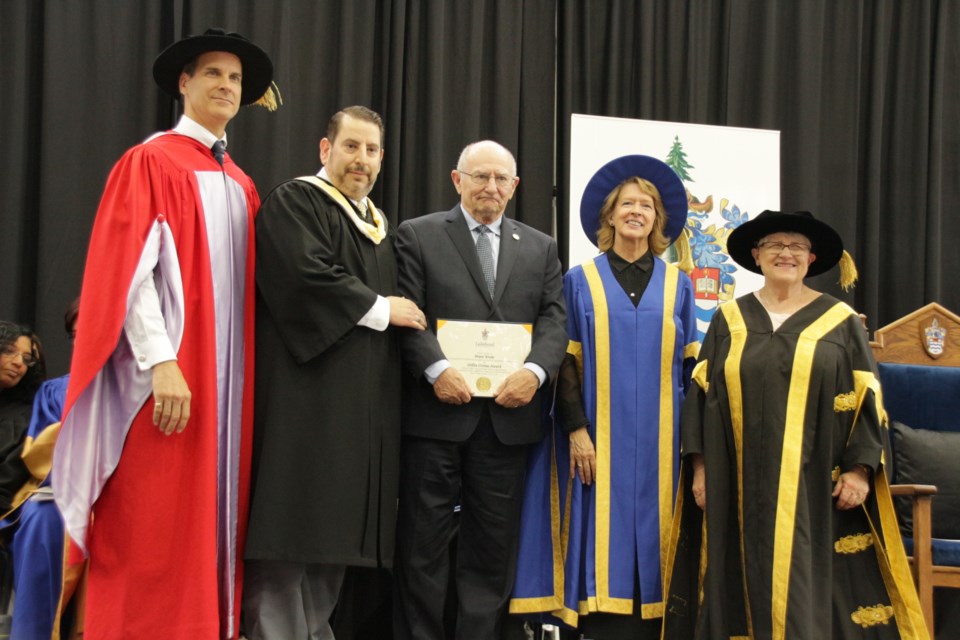 Bruce Waite, centre, received the 2018 Civitas Award at this year’s graduation ceremony. Pictured with him, from left, is Orillia campus principal, Dean Jobin-Bevans, Frank Cappadocia, associate vice president administration and community engagement, Moira McPherson, interim president and vice chancellor, and Lyn McLeod, chancellor. Mehreen Shahid for OrilliaMatters