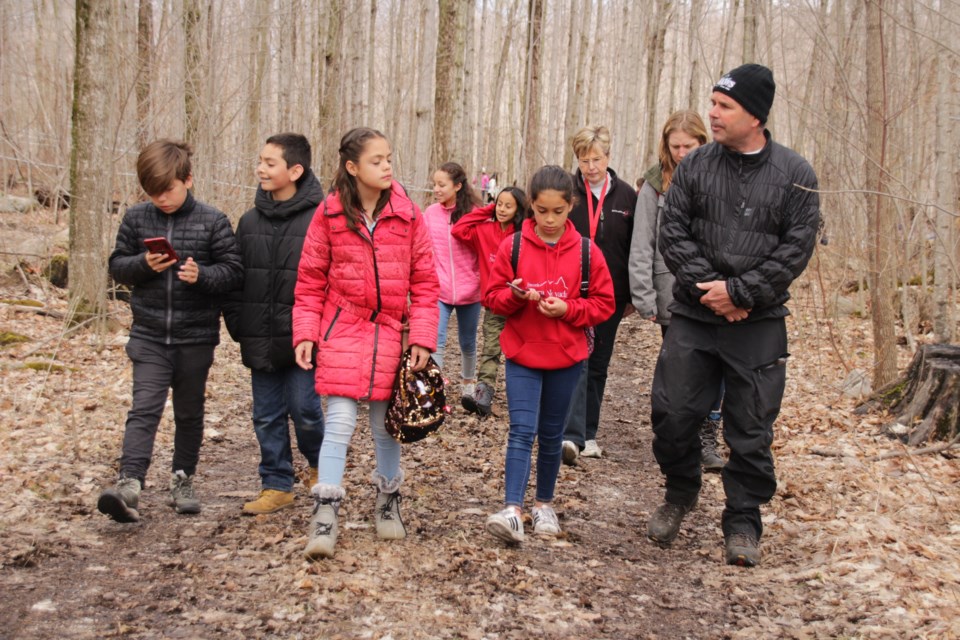 A group of students from Mexico took a walk through the sugar bush Sunday with Tom Shaw, who explained to them the process of producing maple syrup. The students were in the area for two weeks to learn about Canada. Mehreen Shahid/OrilliaMatters
