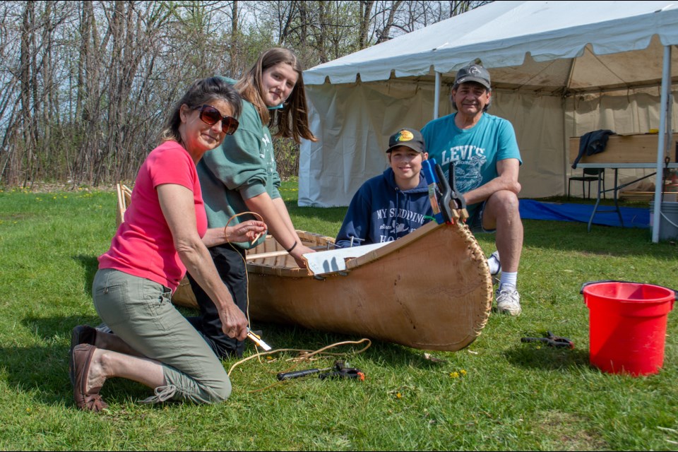 Patrick Fogarty students have been learning about Indigenous culture and history through building a canoe. 
From left are master canoe building assistant Joanne Dumoulim, student Carole Wilson, student Curtis Stoner, and knowledge keeper Chuck Commanda. 