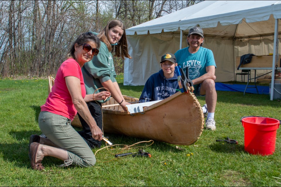 Patrick Fogarty students have been learning about Indigenous culture and history through building a canoe. 
From left are master canoe building assistant Joanne Dumoulim, student Carole Wilson, student Curtis Stoner, and knowledge keeper Chuck Commanda. 