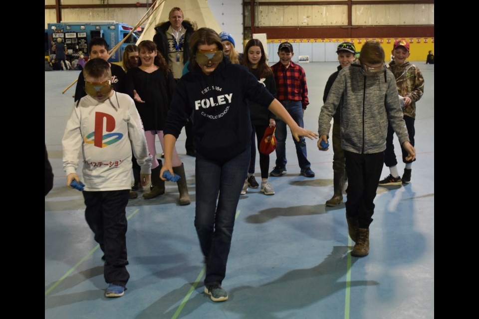 At one of 10 pit stops at Thursday's RACE Against Drugs event, Grade 5 students learned about the effects of impairment by donning special goggles that made easy tasks difficult. Dave Dawson/OrilliaMatters