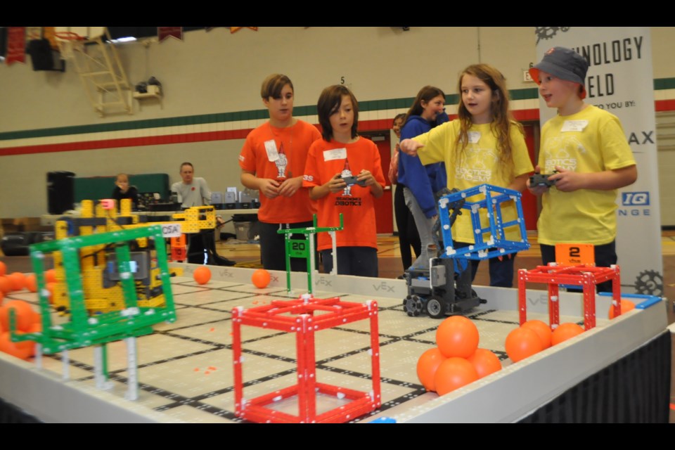 Notre Dame Catholic School students Rachael Kendall and Marcus Milliard (wearing yellow shirts) took part in a teamwork competition against the Clearview Cybergnomes in the Rotary Club of Orillia VEX IQ robotics event for elementary school students held Saturday at Patrick Fogarty. Andrew Philips/OrilliaMatters