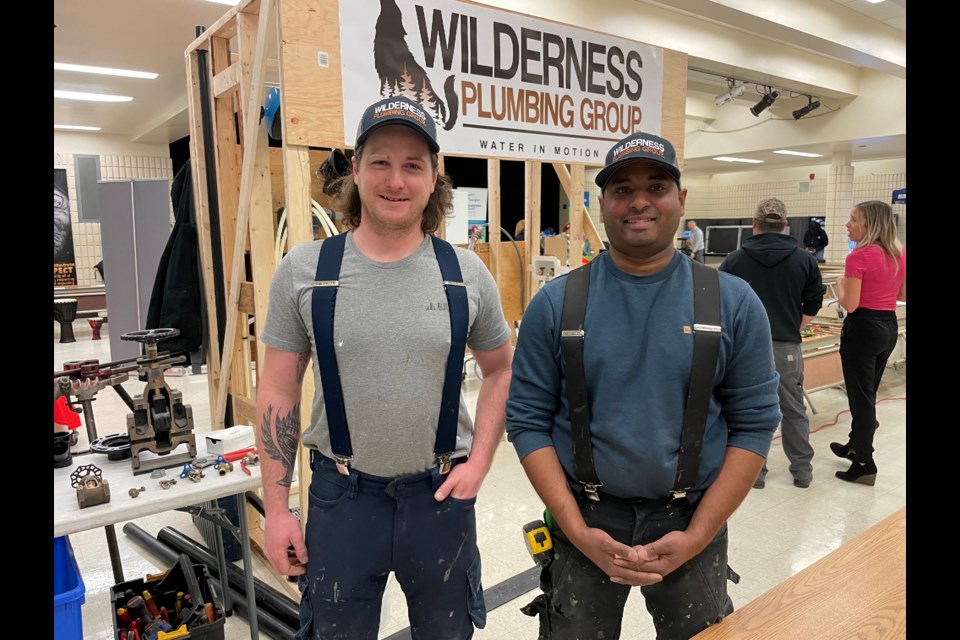 Devon Blunt, left, and Andrew Friesen, owners of Wilderness Plumbing Group, built a mock bathroom, kitchen, and laundry room for the Twin Lakes Secondary School Tech Expo to show students how plumbing works. 