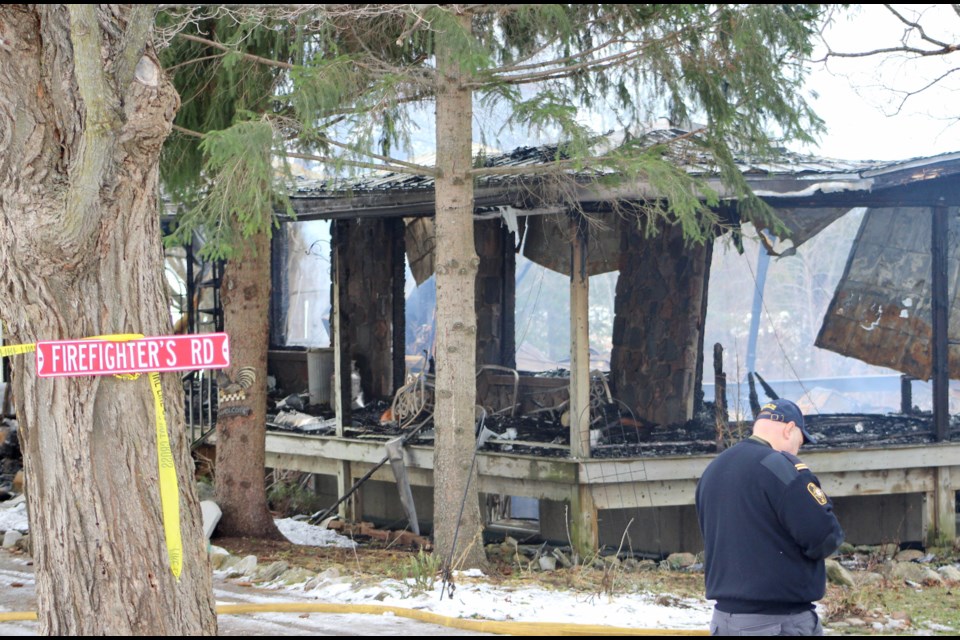 An official with the Office of the Fire Marshal is shown Monday at the scene of a house fire on Line 12 in Oro-Medonte. The fire started Sunday afternoon. Nathan Taylor/OrilliaMatters