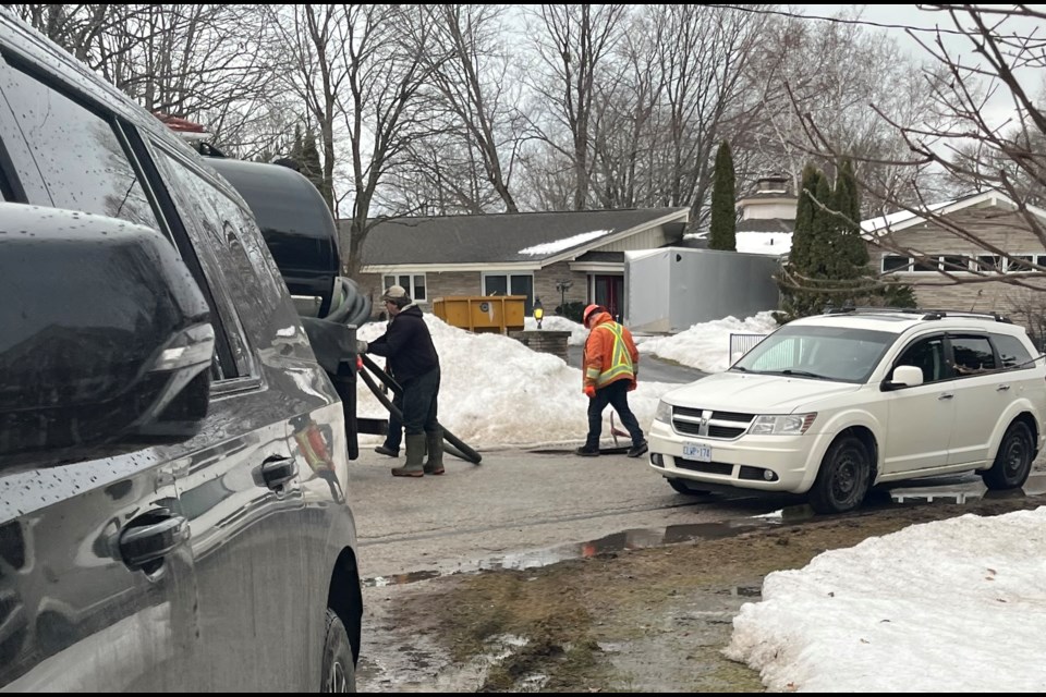 City crews work on Dale Drive as wastewater floods residential streets and driveways during cleanup efforts in the aftermath of the late March ice storm. Residents say vacuum trucks offered only temporary relief.