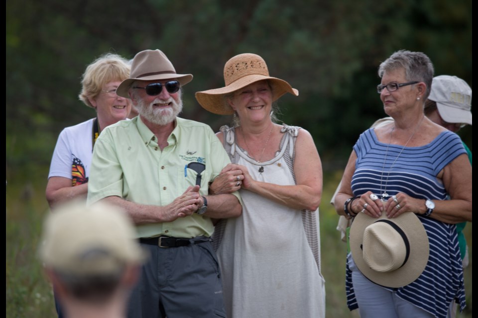 Ron Reid, second from the left, and Janet Grand celebrate among friends and family at the dedication of The Ron Reid Nature Reserve, Sunday. Cameron Curran photo