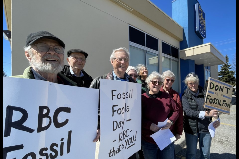 Several local residents joined groups around the country Saturday in staging a protest against RBC's fossil fuel investments. The protesters are shown outside the RBC branch on Monarch Drive in west Orillia.