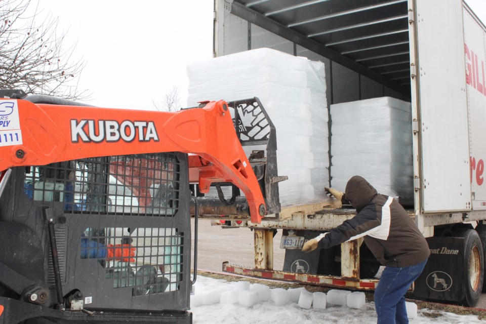 Volunteers including Tim Ticknor (driving) and Bradley Mathews were out in the freezing rain Friday to unload blocks of ice that will become the ice castle at next weekend's Orillia Winter Carnival. Nathan Taylor/OrilliaMatters