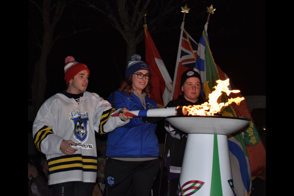 Ethan Franzin, Jessica Stockdale and Ryker Jacobs join their torches together to light the flame that officially marks the opening of the 2018 Ontario Winter Games, hosted by Orillia. The massive event, that includes more than 3,000 athletes competing in 25 sports, officially began Thursday with an impressive opening ceremony at Couchiching Beach Park. Dave Dawson/OrilliaMatters