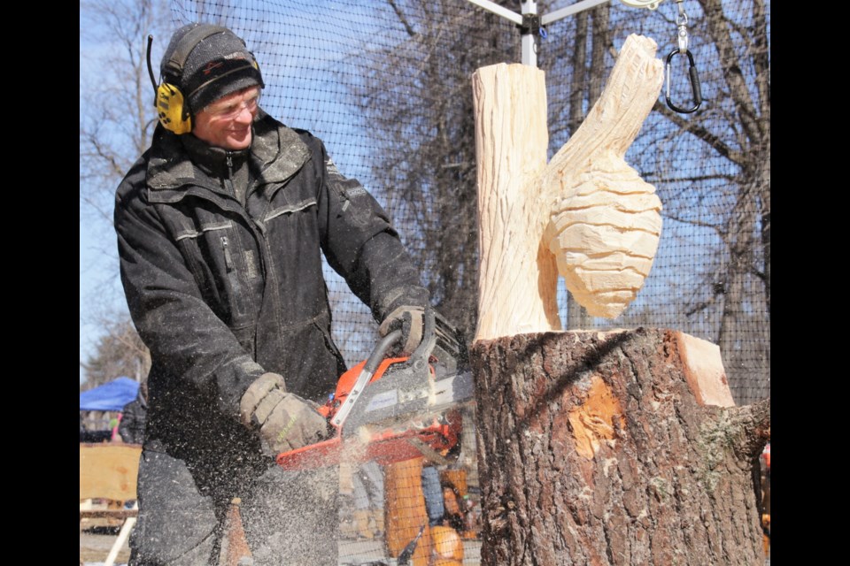 Veteran chainsaw carver Jim Menken works on a custom piece at the 2018 event in Wahago. OrilliaMatters File Photo