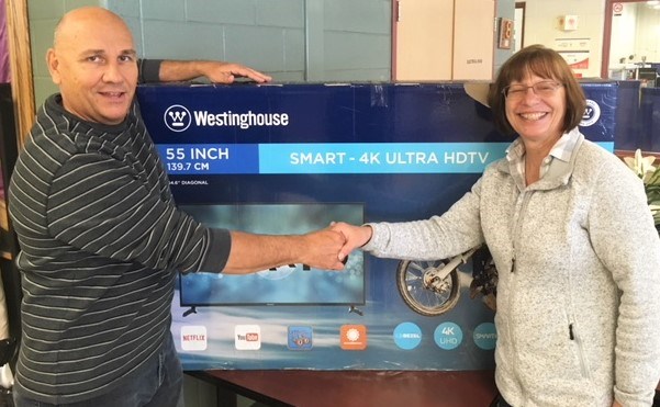 Debbie Russell was the big winner at this weekend’s 25th annual Simcoe Spring Home and Cottage Show. She won a 55" Ultra HD TV courtesy of Wagner Lawn Care. She is shown with her prize alongside Glenn Wagner, manager of the show.
