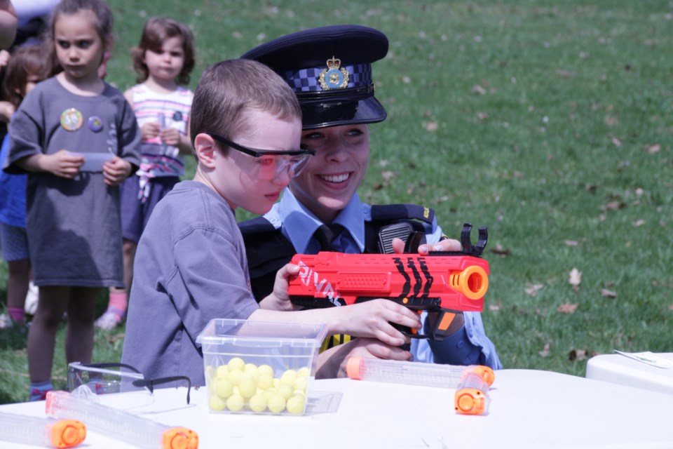 Jacob Ewing, 6, of Smithville, was helped by auxiliary constable Paige Burton in the nerf zone at the OPP Kids Day events at Tudhope Park. Mehreen Shahid/OrilliaMatters